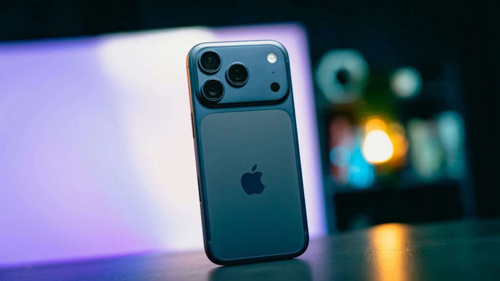 Blue smartphone with apple logo on dark background